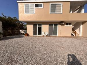 a shadow of a person standing in front of a house at Almar in Olón