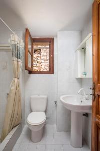 a bathroom with a toilet and a sink at Isminis Villa in Halki +46 photos