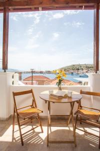 a table and two chairs on a balcony with a view at Isminis Villa in Halki