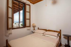 a bedroom with a bed and a window at Isminis Villa in Halki