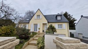 a yellow house with some stairs in front of it at les HAUTS de SAINT SATURNIN in Saint-Saturnin