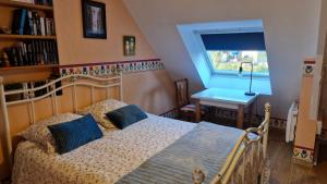 a bedroom with a bed and a window and a table at les HAUTS de SAINT SATURNIN in Saint-Saturnin