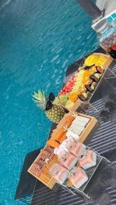 a table of food next to a swimming pool at Areenachalet in Ibrā