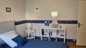 a bedroom with a blue bed and a heart trophy at les HAUTS de SAINT SATURNIN in Saint-Saturnin