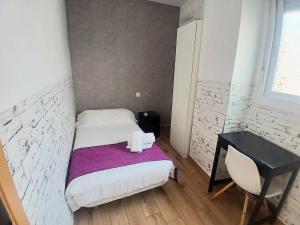 a small bedroom with a bed and a desk at Habitaciones El Escorial in Majadahonda
