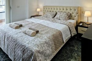 a bedroom with a large bed with two pillows at Panorama Sky Apartment in Sarandë