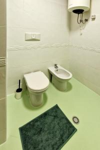 a bathroom with a toilet and a sink at Panorama Sky Apartment in Sarandë +12 photos