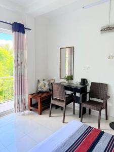 a room with a desk and chairs and a window at NO 10 Kandy by Kepler & Earth in Kandy +20 photos