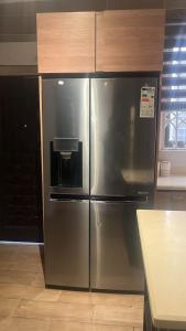 a stainless steel refrigerator in a kitchen at Elista Home in Tema