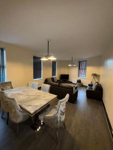 a living room with a table and a couch at Smithdown Hideaways in Liverpool