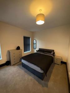 a bedroom with a large bed and a light at Smithdown Hideaways in Liverpool