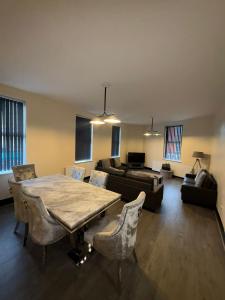 a living room with a table and a couch at Smithdown Hideaways in Liverpool