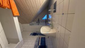 a bathroom with a sink and a toilet in it at Ferienwohnung Roseggersiedlung in Murau