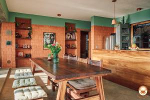 a dining room with a wooden table and chairs at Coyote, 7BR Ocean View Villa, 2 Pools, Zipolite in Puerto Ángel