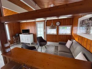 a living room with a couch and a table at Haus Haddorfer See "Hus vi d Sjön" in Wettringen