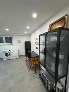 a living room with a table and a washing machine at Large Wuerzburg Apartment in Würzburg