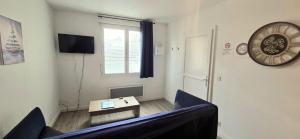 a living room with a couch and a table at Le Babord T2 étoilé in Saint-Méloir-des-Ondes +16 photos