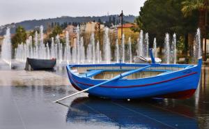 a blue boat in front of a fountain at "Le Zen" by EnjoyNice, central spacious apartment with Airco, beach at 10 min in Nice