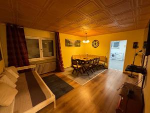 a living room with a table and a dining room at Large Wuerzburg Apartment in Würzburg