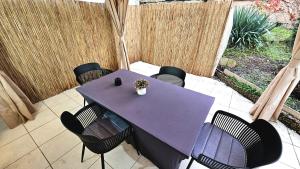 a purple table and chairs on a patio at Ioana Homes Ferienwohnung in Abstatt