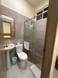a bathroom with a toilet and a sink and a shower at Almar in Olón +22 photos