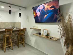 a living room with a large screen on the wall at Coral del mar in Tolú