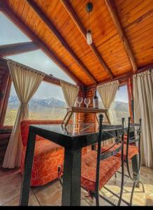 a room with a table and a couch and a window at Aventurados in Potrerillos