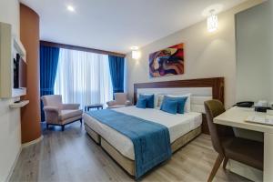 Postel nebo postele na pokoji v ubytování Forum Suite Otel