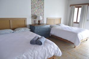a bedroom with two beds with towels on them at Hooked on Panama Lodge in Limones +7 photos