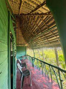 a row of benches sitting inside of a building at Lakeview Birdsong Cabanas in Debarawewa