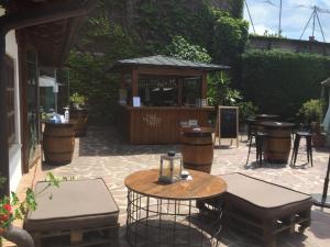 a patio with a table and chairs and a bar at Hostal Restaurante Casa Santamaria in Doneztebe