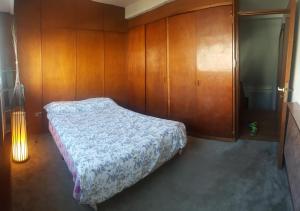 Ένα ή περισσότερα κρεβάτια σε δωμάτιο στο Hospedaje 12