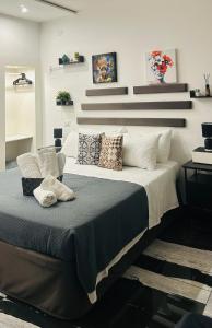 a bedroom with a large bed with pillows on it at La casa di Sesè in Viagrande