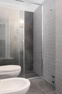 a bathroom with a shower with a toilet and a sink at Hotel Dante in Cattolica