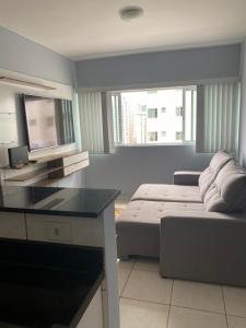 a living room with a couch and a table at Hospedagem Executiva Águas Claras in Brasília