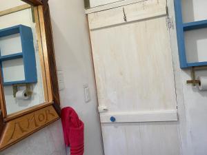 a door with a red glove next to a mirror at Milagros in La Paloma +22 photos