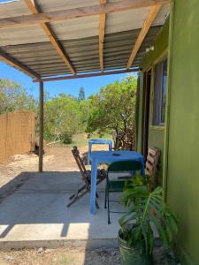 a blue table and chairs on a patio at Milagros in La Paloma