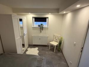 a small room with a window and a chair at Ferienwohnung Meister in Mayen