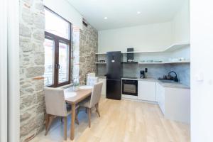 a kitchen with a table and chairs in a room at MONOPATI HOUSE in Mouzaki +59 photos