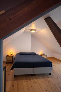 a bedroom with a large bed in a attic at L'industriel - meublé de tourisme 4 étoiles in Fécamp