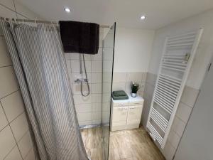 a bathroom with a shower with a shower curtain at Ferienwohnung Meister in Mayen