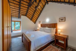 a bedroom with a large white bed and a window at Kruger Park Lodge Unit No 219 in Hazyview +38 photos