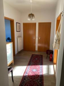 a room with two doors and a rug on the floor at Stadtgarten in Meißen