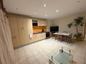 a kitchen with a table and a dining room at Appartement Cosy in Wolfersdorf