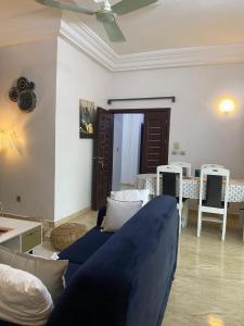 a living room with a blue couch and a table at Dares Salaam in Cotonou