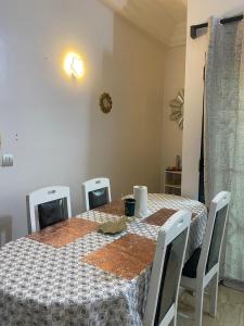 a dining room table with chairs and a tablecloth on it at Dares Salaam in Cotonou +7 photos