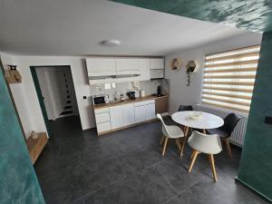 a kitchen and dining room with a table and chairs at Casa Apartament Refugiul Dornean in Vatra Dornei +19 photos