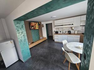 a kitchen and dining room with a table and chairs at Casa Apartament Refugiul Dornean in Vatra Dornei