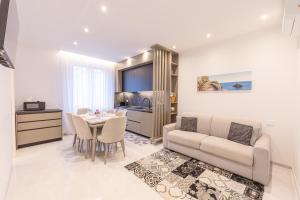 a living room with a couch and a table at Affittacamere Sulle Stelle in La Spezia