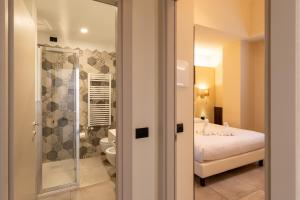 a bedroom with a bed and a glass shower at Del Prado in Riva Ligure +202 photos